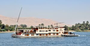 Dahabiya vs Nile cruise - traditional dahabiya boat sailing the Nile, Egypt