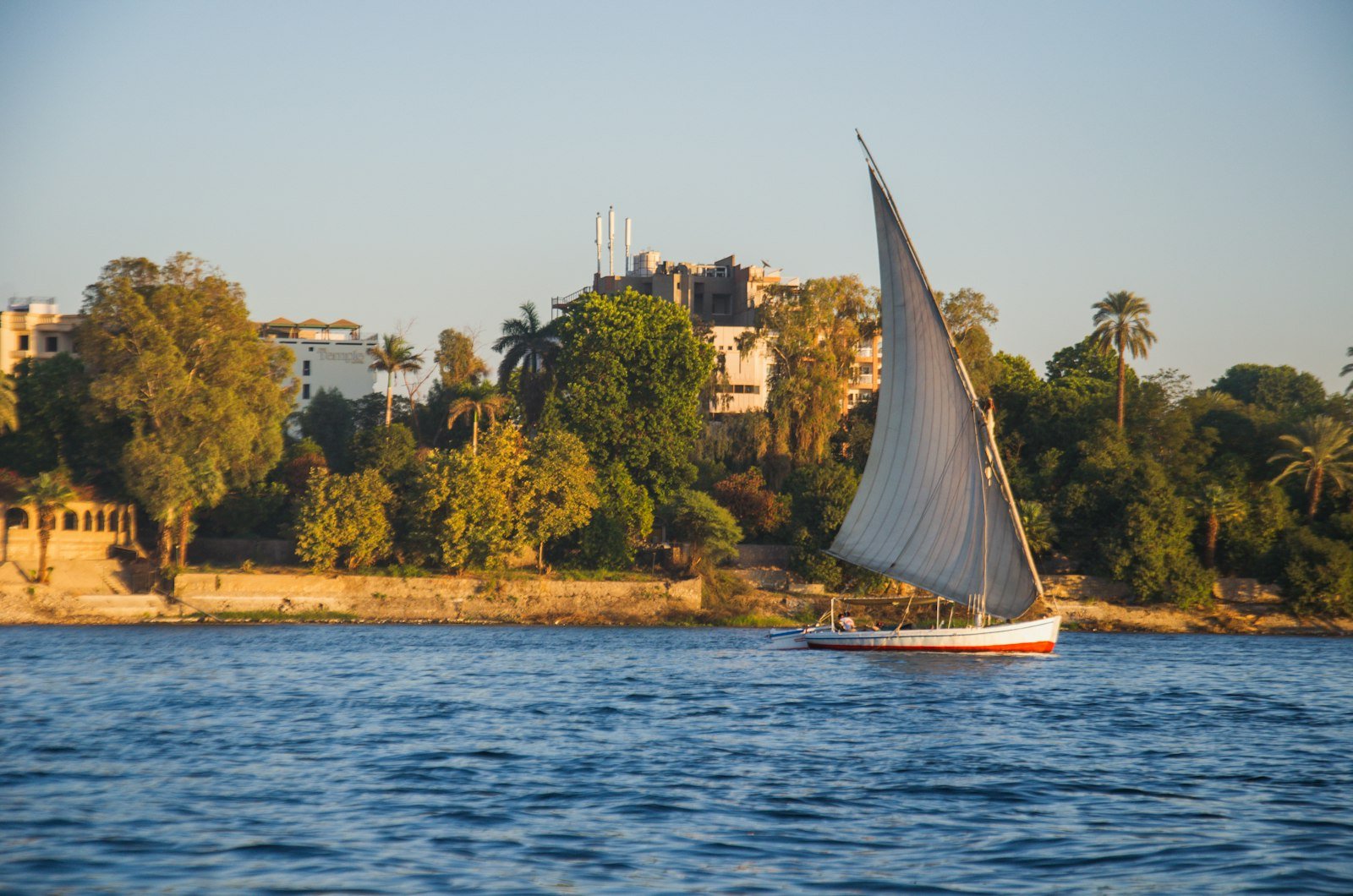 Traditional felucca sailing the Nile River near Aswan, Egypt