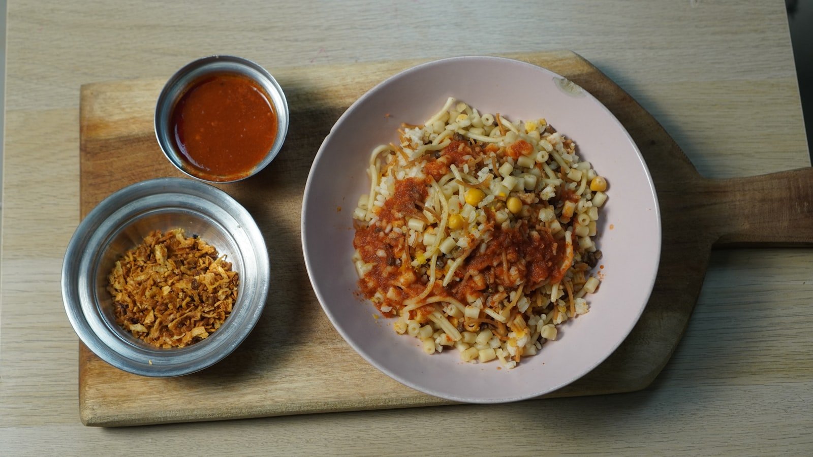 Traditional koshari, Egypt’s national dish of rice, pasta, lentils, and spiced tomato sauce
